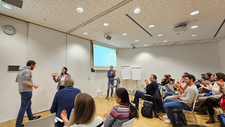 A photograph of one of the PhD best paper awards being presented to Jonas Frerick.