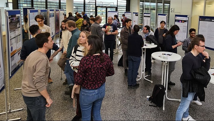 A photograph of one of the lively exchange and discussion at the well attended poster session.