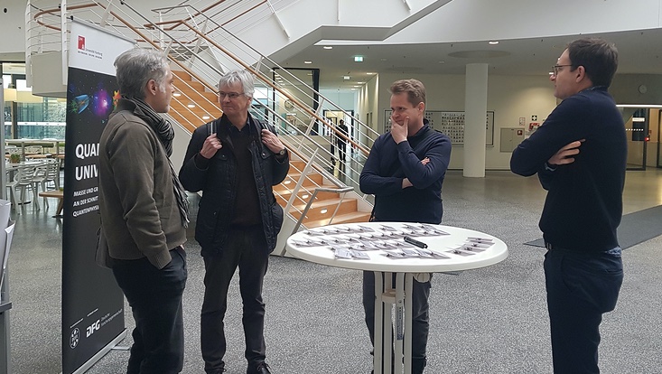 A photograph of one of the exchanges between Principal Investigators: (L to R) Dieter Horns, Jan Louis, Oliver Gerberding & Timo Weigand.